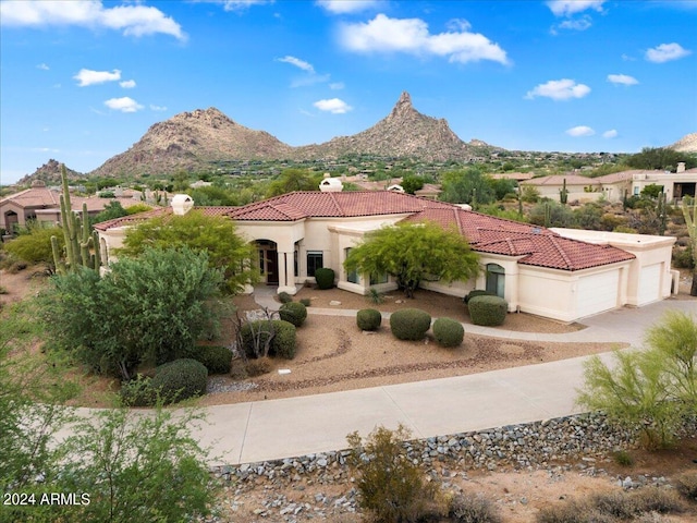 mediterranean / spanish home with a mountain view and a garage