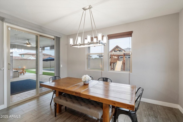 10702 E Sheffield Dr, Mesa, AZ 85212 - dining space with ceiling fan with notable chandelier, a healthy amount of sunlight, and hardwood / wood-style floors