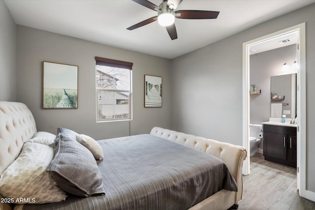 10702 E Sheffield Dr, Mesa, AZ 85212 - bedroom featuring ceiling fan, ensuite bath, and light hardwood / wood-style floors