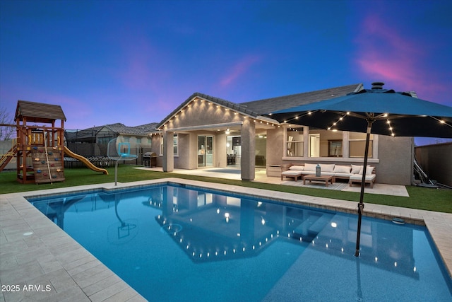 10702 E Sheffield Dr, Mesa, AZ 85212 - pool at dusk featuring an outdoor living space, a patio, a trampoline, and a playground