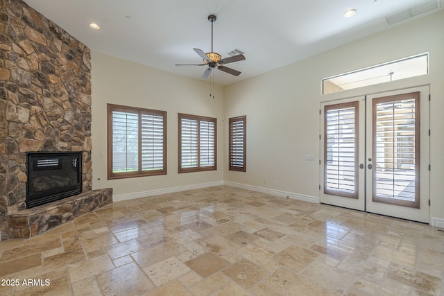 unfurnished living room featuring french doors, visible vents, a fireplace, and baseboards