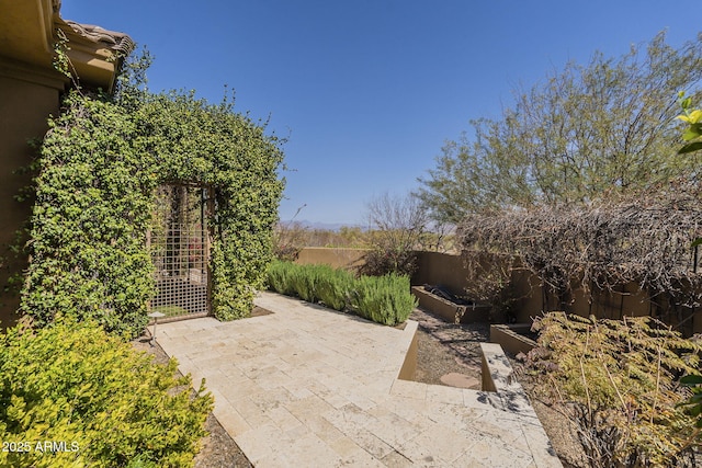 view of patio / terrace with a garden and fence