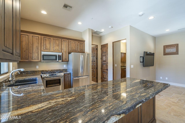 kitchen with stainless steel appliances, recessed lighting, visible vents, and a sink