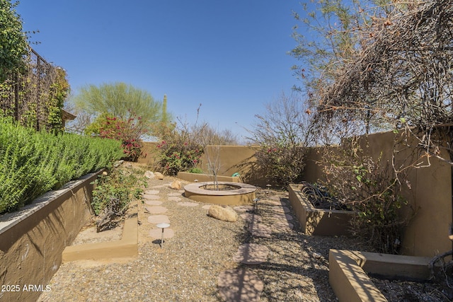 view of yard featuring a garden and a fenced backyard