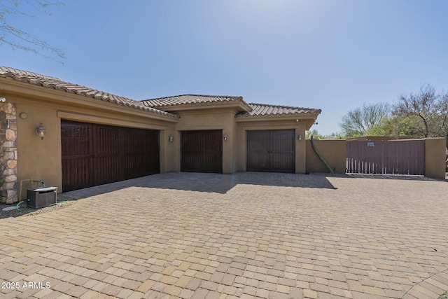 garage with a gate and decorative driveway