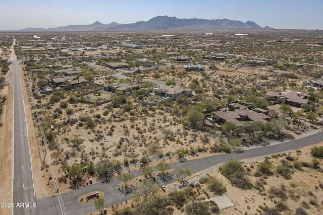 birds eye view of property featuring a mountain view and view of desert