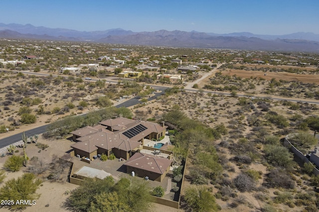 birds eye view of property with view of desert and a mountain view