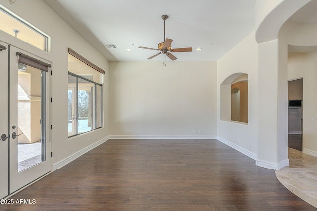 unfurnished room with dark wood-style floors, french doors, visible vents, and baseboards