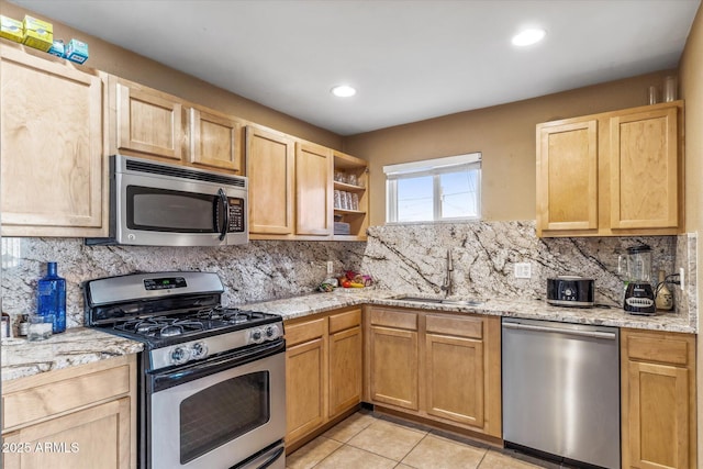 kitchen with light tile patterned flooring, stainless steel appliances, sink, and decorative backsplash