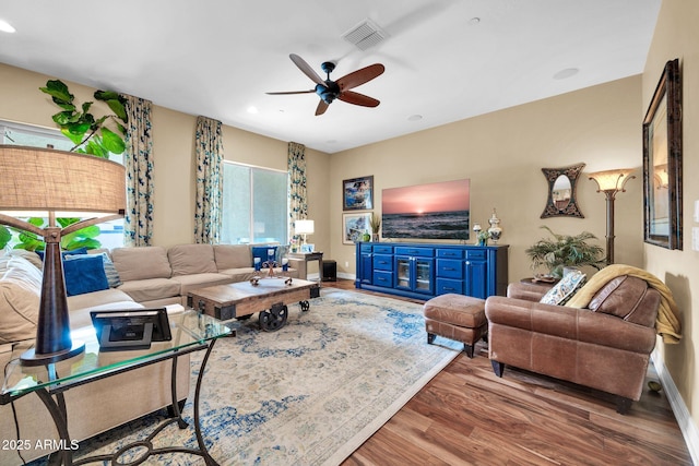 living room with ceiling fan and hardwood / wood-style floors