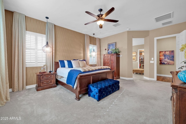 bedroom with ceiling fan and light colored carpet