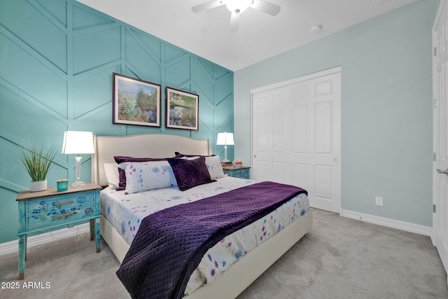 bedroom featuring ceiling fan, light colored carpet, and a closet