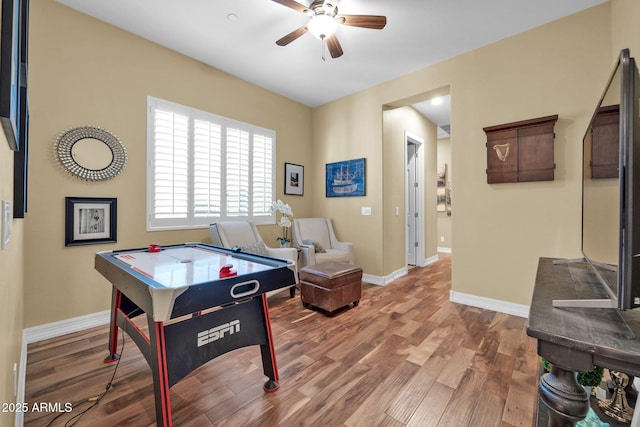 recreation room featuring ceiling fan and hardwood / wood-style floors