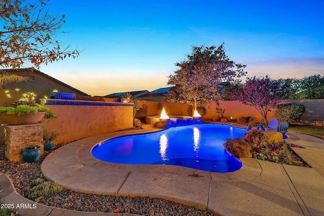 pool at dusk featuring a patio area