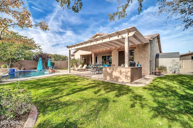 rear view of house featuring a fenced in pool, a yard, a bar, and a patio