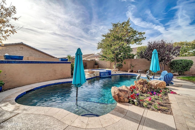 view of swimming pool with an in ground hot tub, pool water feature, and a patio