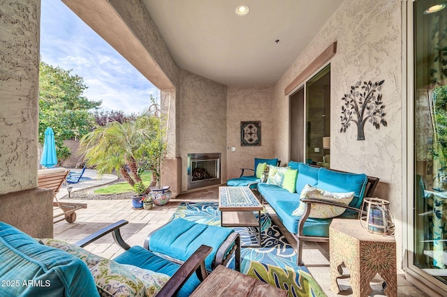 view of patio / terrace featuring an outdoor living space with a fireplace