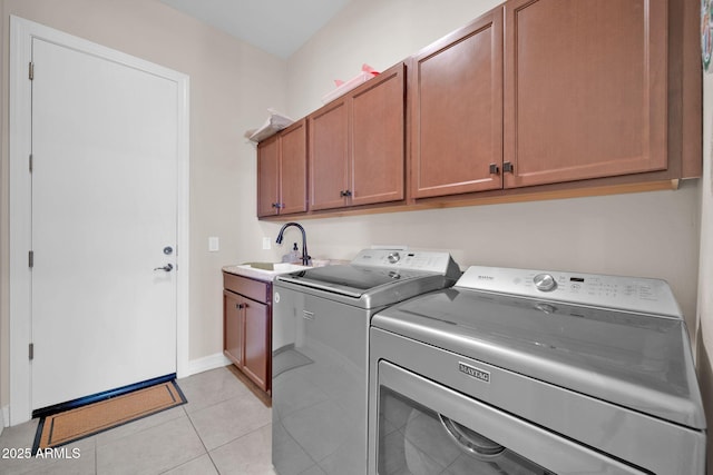 clothes washing area with light tile patterned floors, independent washer and dryer, sink, and cabinets