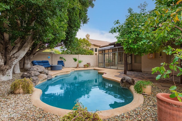 view of swimming pool featuring a patio area, a fenced backyard, and a fenced in pool