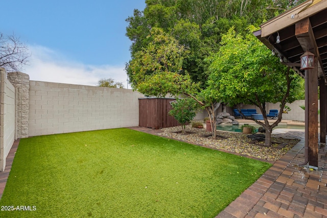 view of yard with a fenced backyard and a patio