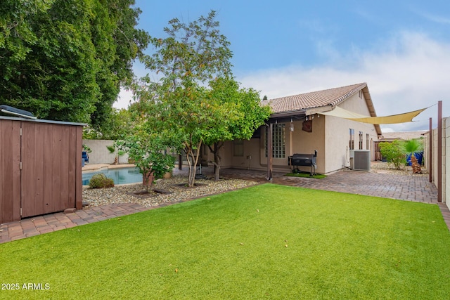 view of yard featuring central AC, a patio, a fenced backyard, and a fenced in pool