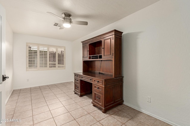 unfurnished office featuring ceiling fan, light tile patterned floors, visible vents, and baseboards