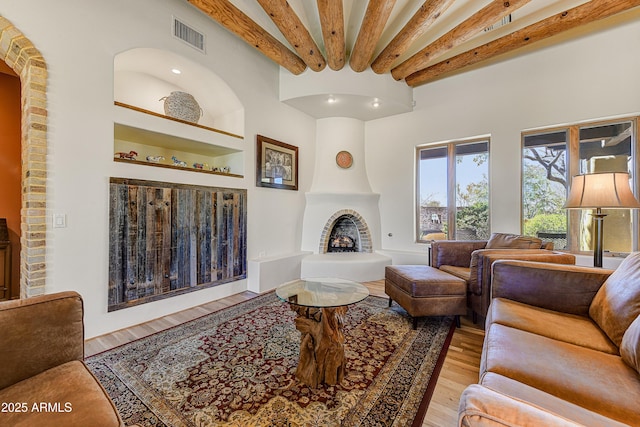 9415 N 124th St, Scottsdale, AZ 85259 - living room with a large fireplace, light wood-style flooring, beam ceiling, and recessed lighting
