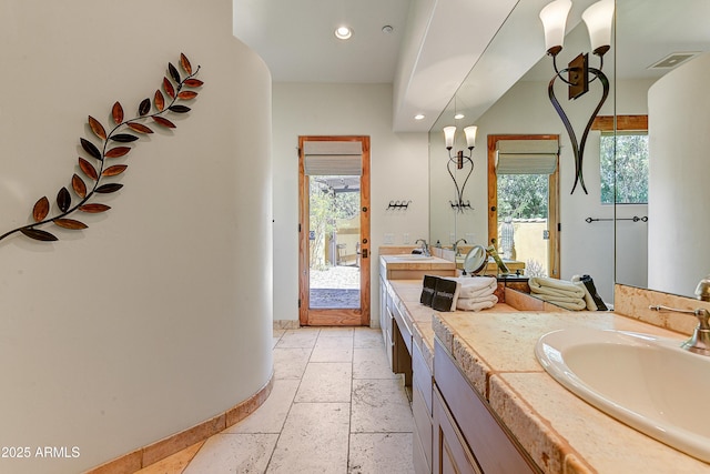 9415 N 124th St, Scottsdale, AZ 85259 - full bathroom featuring recessed lighting, double vanity, baseboards, and stone tile flooring