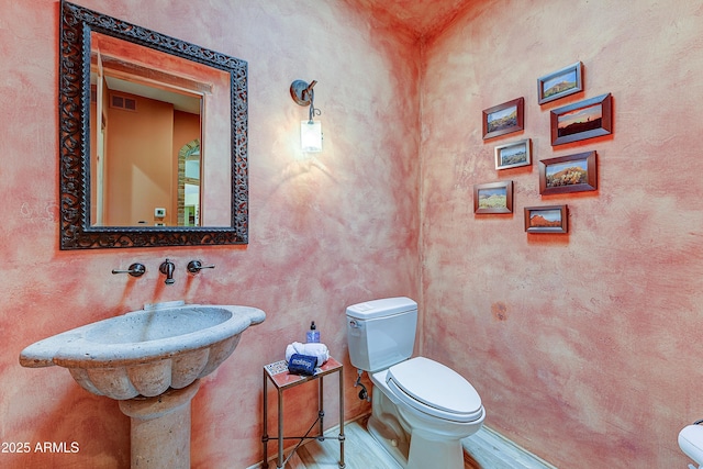 9415 N 124th St, Scottsdale, AZ 85259 - half bath featuring toilet and wood finished floors