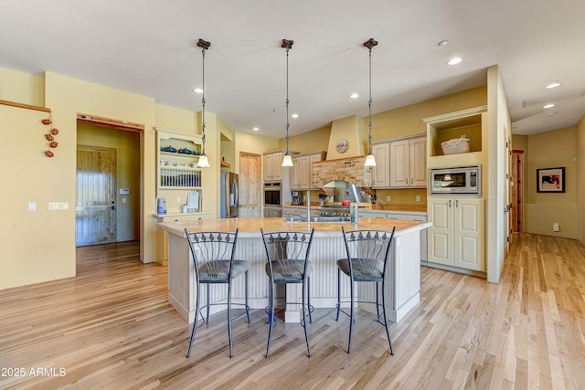 9415 N 124th St, Scottsdale, AZ 85259 - kitchen featuring open shelves, appliances with stainless steel finishes, custom exhaust hood, light wood-style floors, and recessed lighting