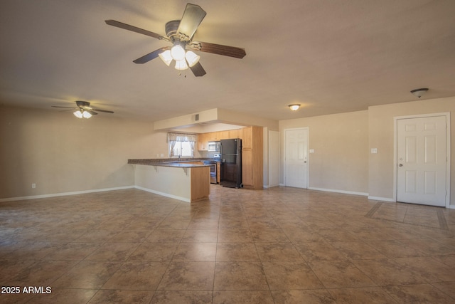 unfurnished living room with baseboards, a ceiling fan, and tile patterned floors