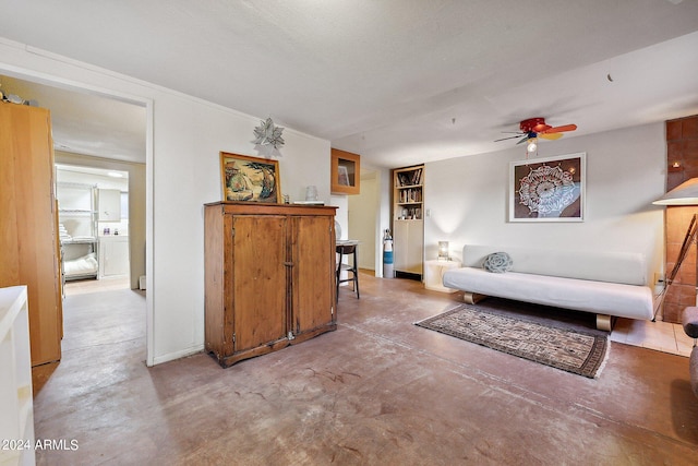 interior space with concrete floors, ceiling fan, and a textured ceiling