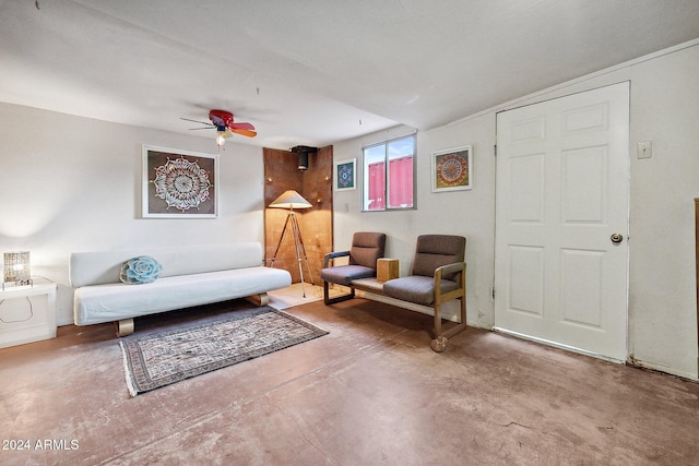 living room with concrete flooring and ceiling fan