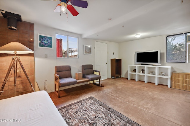 living room featuring ceiling fan and concrete floors