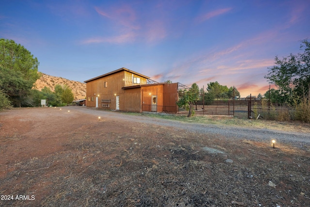 property exterior at dusk with a mountain view