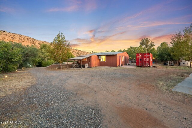 view of front facade featuring an outdoor structure and a mountain view