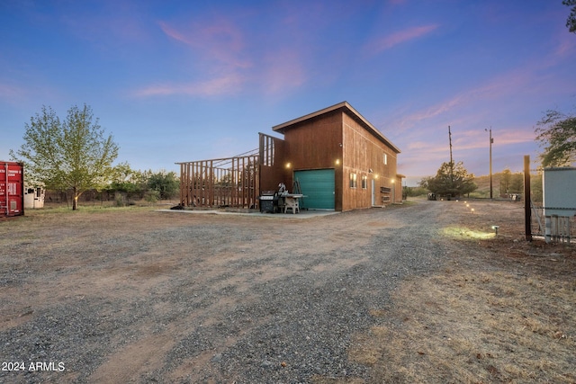 outdoor structure at dusk with a garage