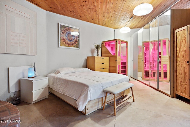 bedroom featuring wood ceiling and concrete flooring