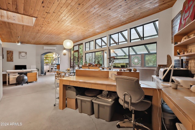 carpeted home office with a skylight, wooden ceiling, a healthy amount of sunlight, and a wall mounted AC