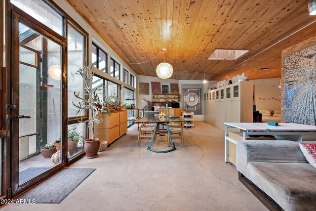 interior space with lofted ceiling with skylight and wooden ceiling