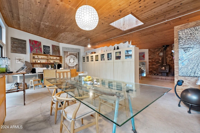 dining room with a skylight, a wood stove, and wooden ceiling