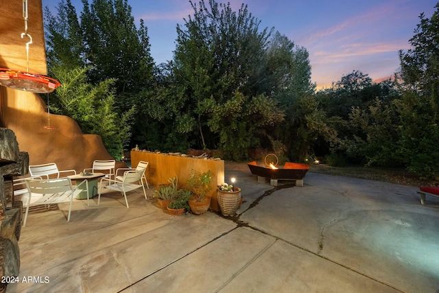 patio terrace at dusk with a fire pit