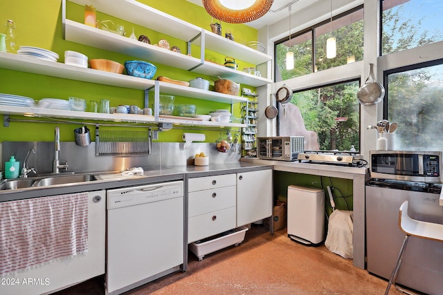 kitchen with white cabinetry, sink, white dishwasher, and stainless steel counters