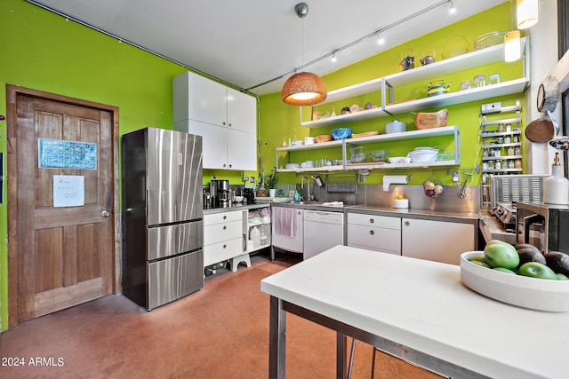 kitchen with white cabinets, white dishwasher, hanging light fixtures, stainless steel fridge, and stainless steel counters