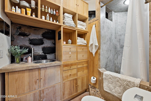 bathroom with walk in shower, vanity, and toilet