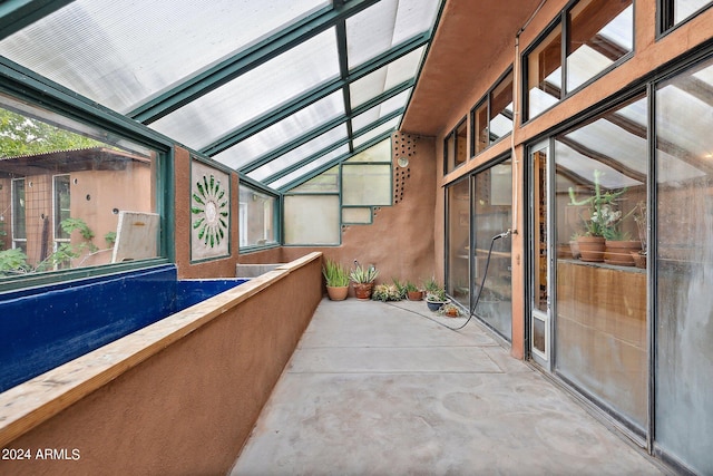 unfurnished sunroom with lofted ceiling