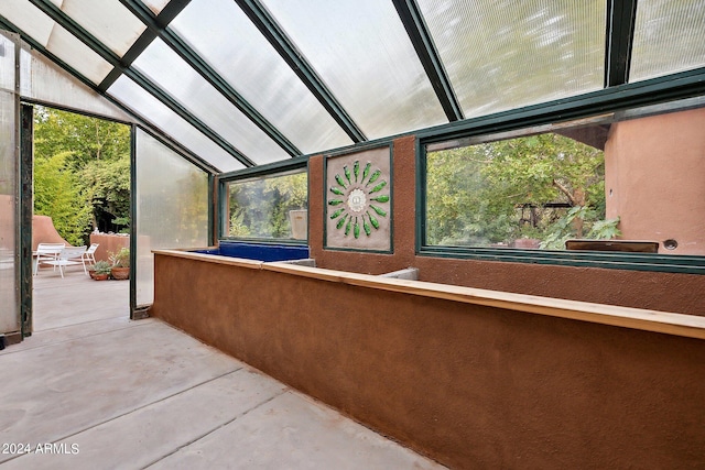 unfurnished sunroom featuring lofted ceiling