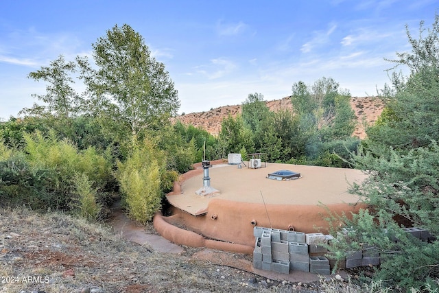 view of community featuring a mountain view and a patio area