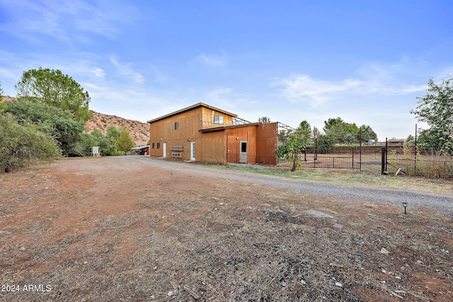 view of side of home featuring a rural view and a mountain view