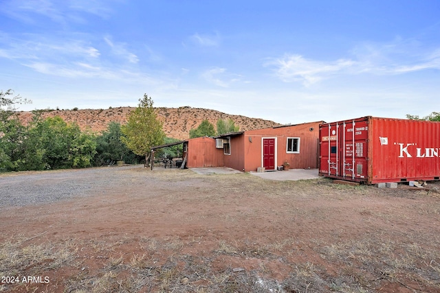 back of property featuring a mountain view